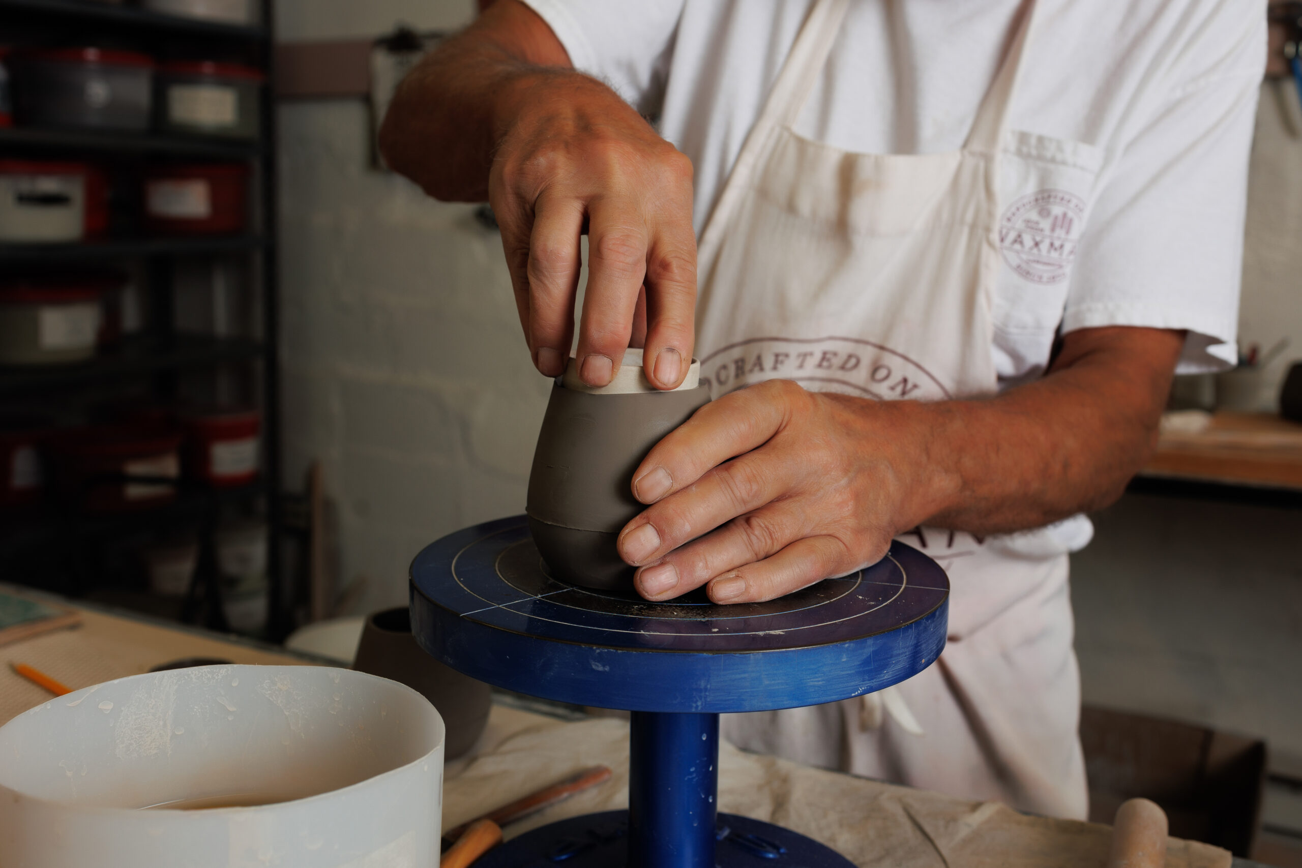 Waxman's owner, Bob, rounds out the top of wine cup in Waxman's ceramic studio.