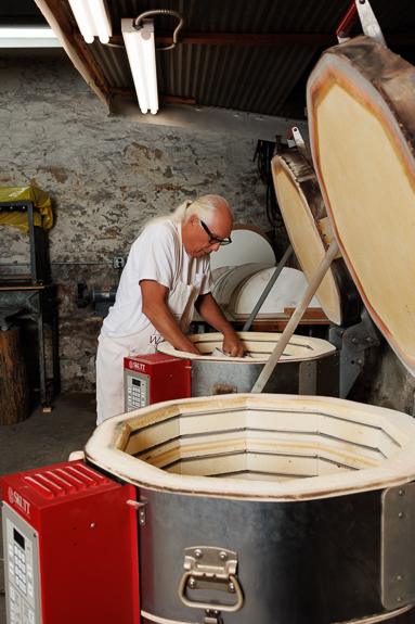 Waxman's owner, Bob, loading two kilns in Waxman's ceramic studio.